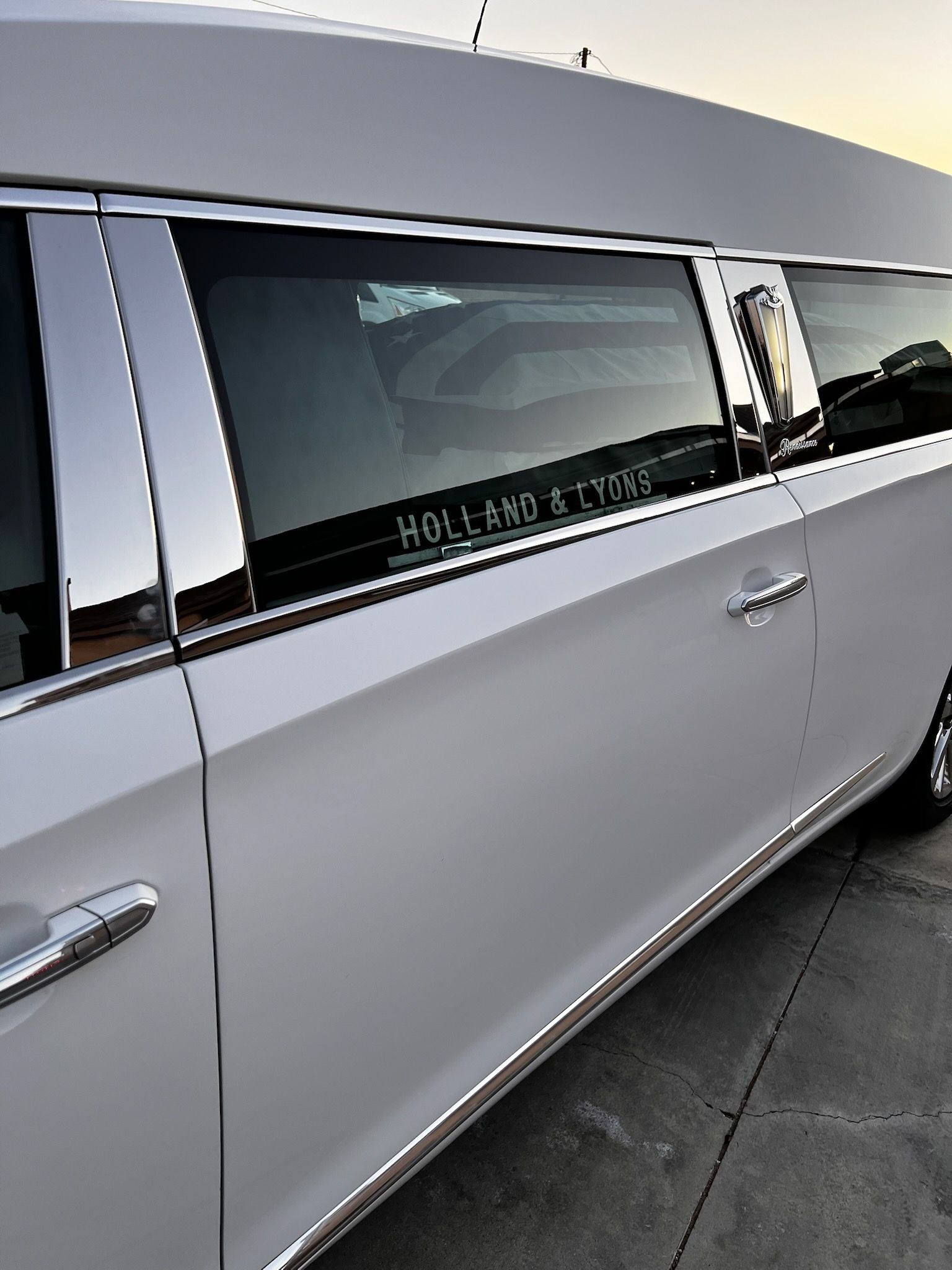 White hearse with chrome accents; 