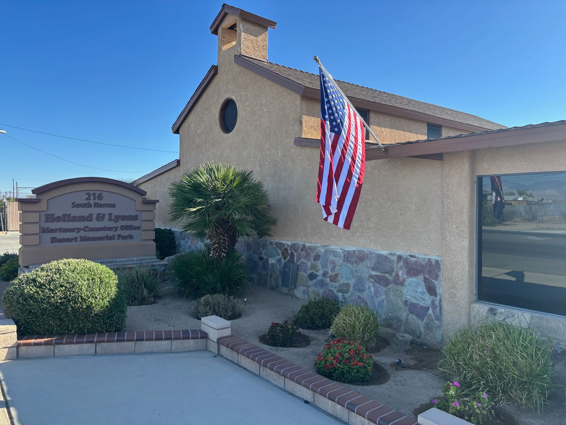 Building with American flag; sign reads 