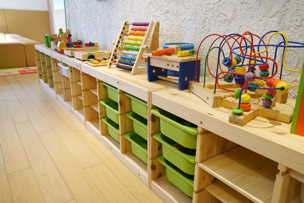 A Row Of Wooden Shelves Filled With Toys In A Room — Wyong Commercial Cleaning In Gosford, NSW