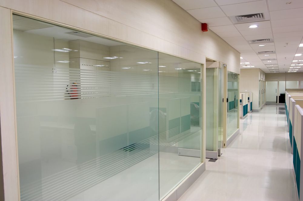 A Hallway With Glass Walls And Cubicles In An Office — Wyong Commercial Cleaning In Tuggerah, NSW