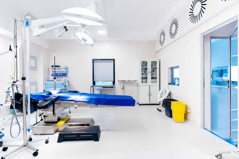 An Empty Operating Room In A Hospital With A Blue Bed — Wyong Commercial Cleaning In Berkeley Vale, NSW