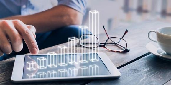 man checking the bar chart on a tablet