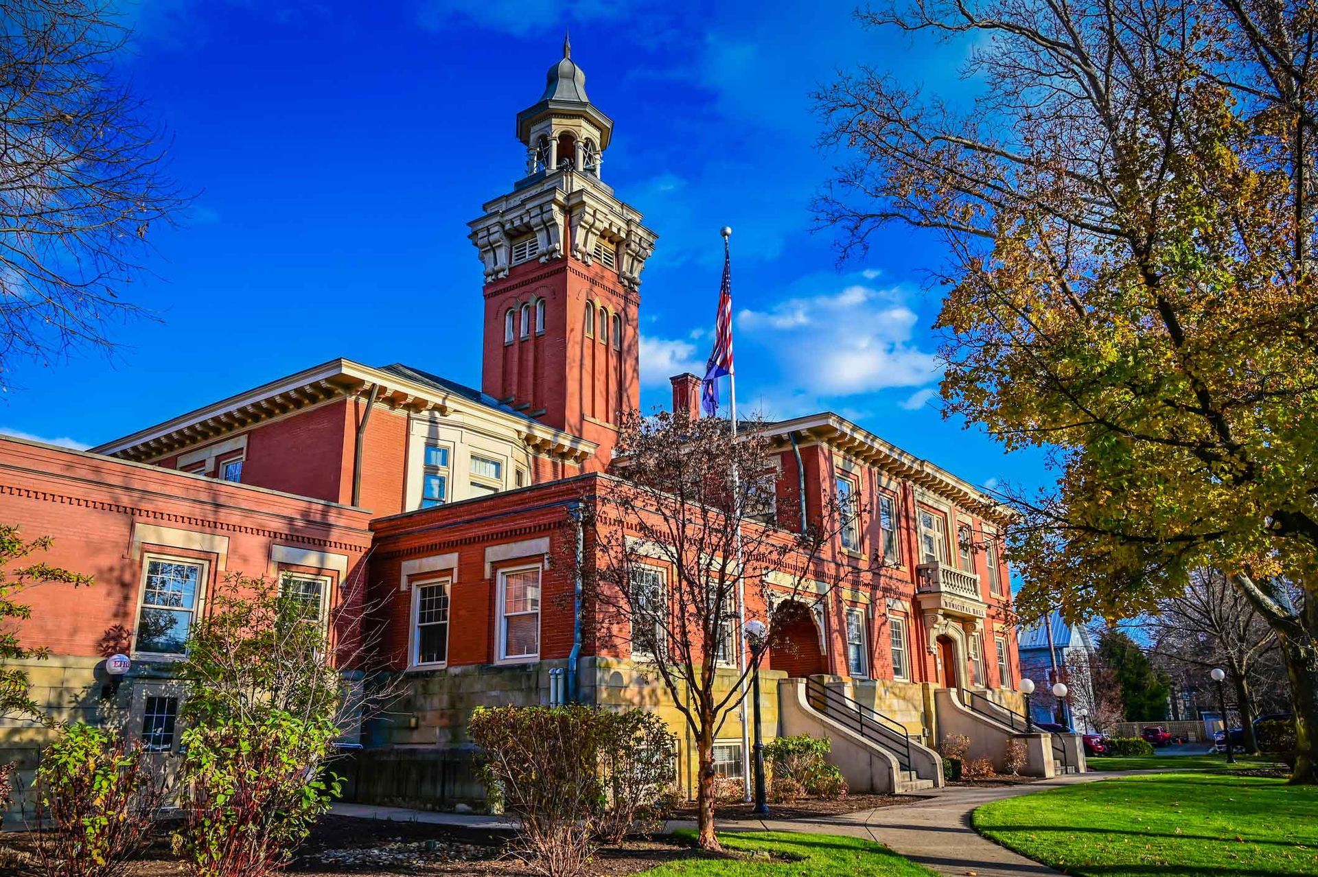 A large red brick building with a clock tower on top of it.