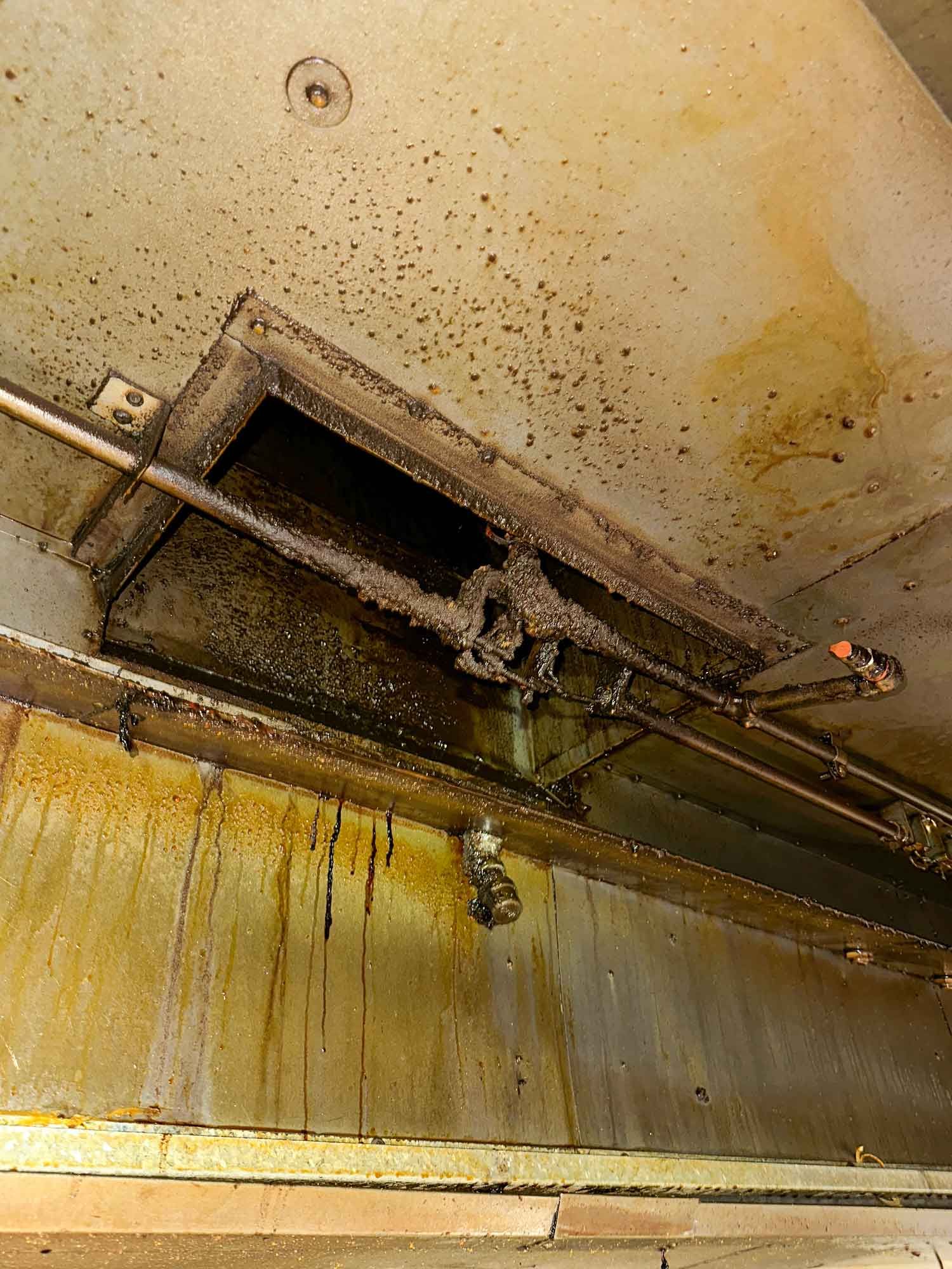 A dirty kitchen hood with a lot of stains on it.