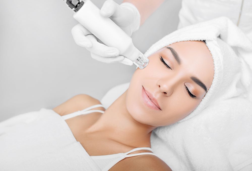 A Woman is Getting a Microneedling Treatment — Coastal Skin & Laser in Caloundra, QLD