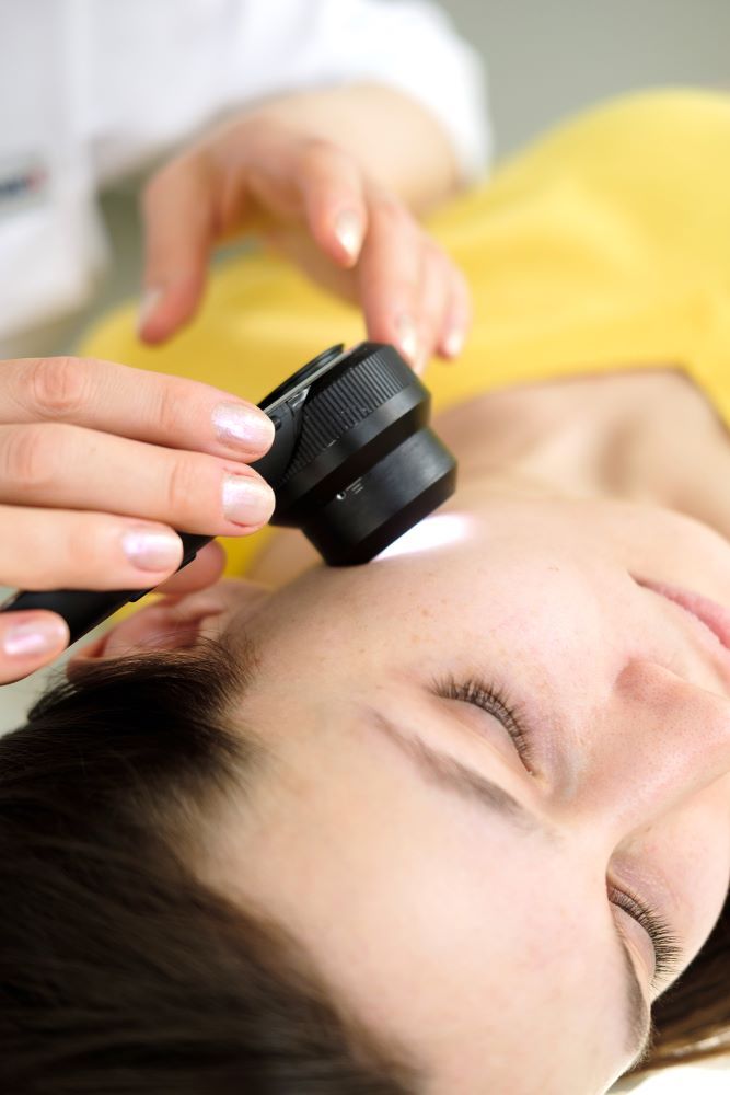 A Woman is Being Examined by a Doctor — Coastal Skin & Laser in Maroochydore, QLD