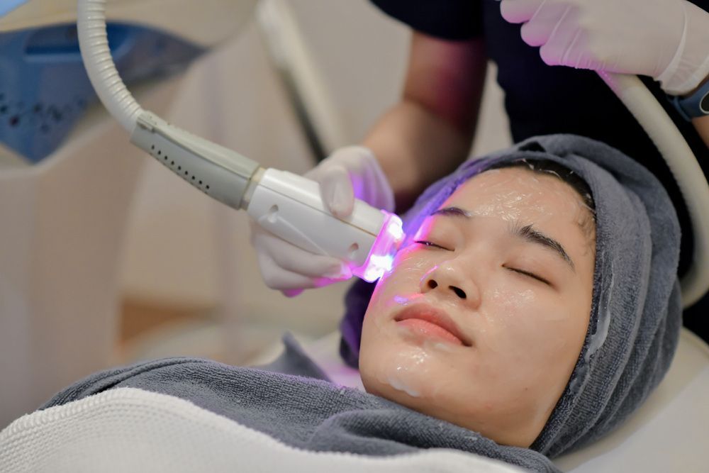 A Woman is Getting a Laser Treatment on Her Face — Coastal Skin & Laser in Noosa, QLD