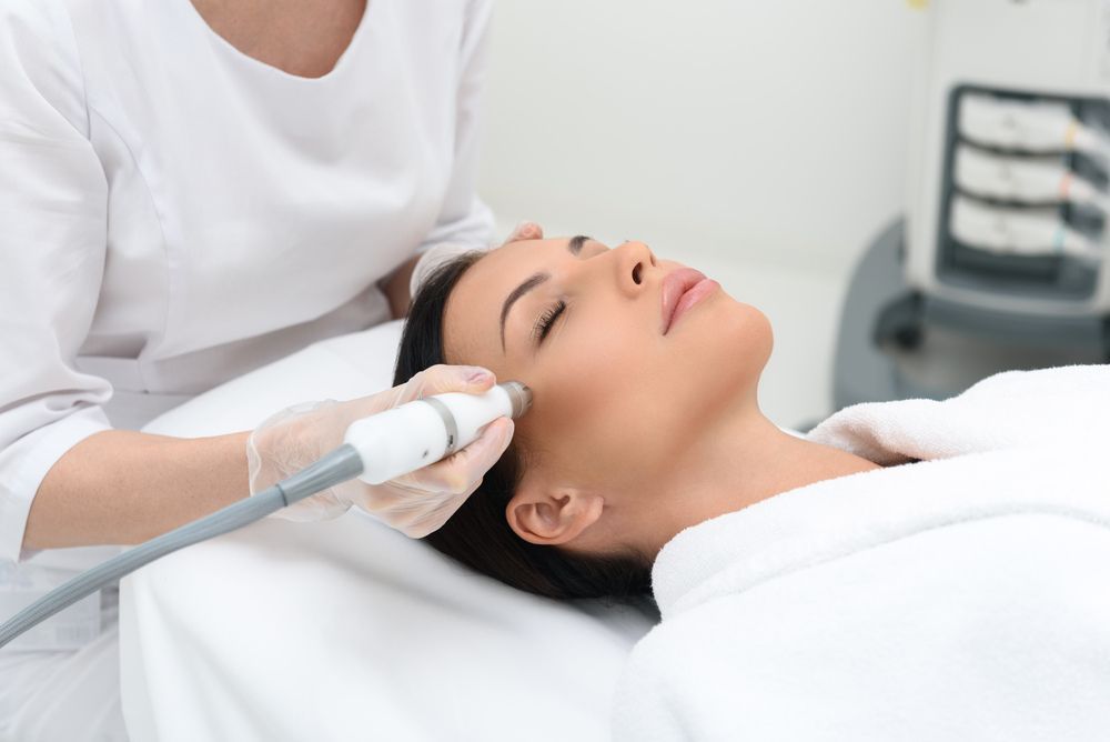 A Woman is Getting a Facial Treatment — Coastal Skin & Laser in Caloundra, QLD