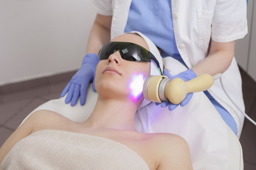 A Woman is Getting a Laser Treatment on Her Face — Coastal Skin & Laser in Coolum, QLD