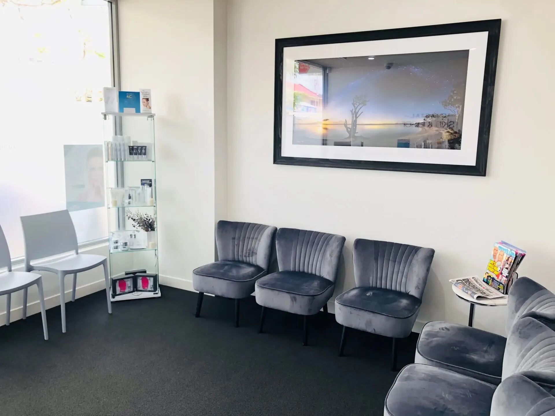 A Waiting Room With Chairs and a Picture on the Wall — Coastal Skin & Laser in Tewantin, QLD