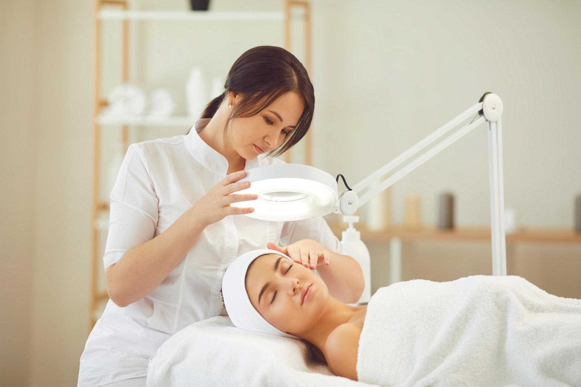 A Woman is Getting a Facial Treatment at a Beauty Salon — Coastal Skin & Laser in Caloundra, QLD