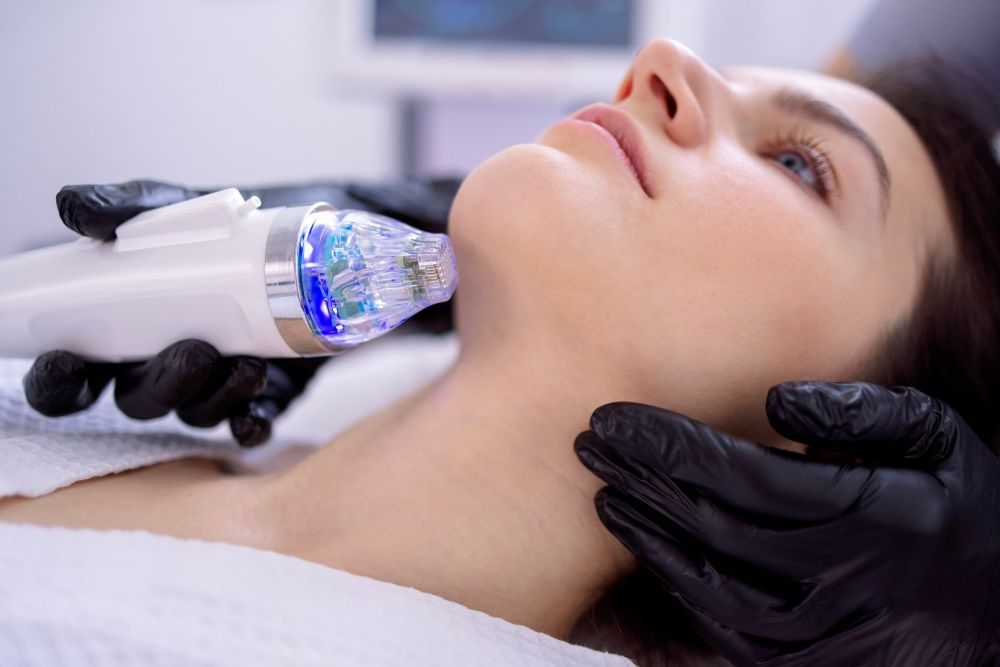 A Woman is Getting a Facial Treatment at a Beauty Salon — Coastal Skin & Laser in Tewantin, QLD