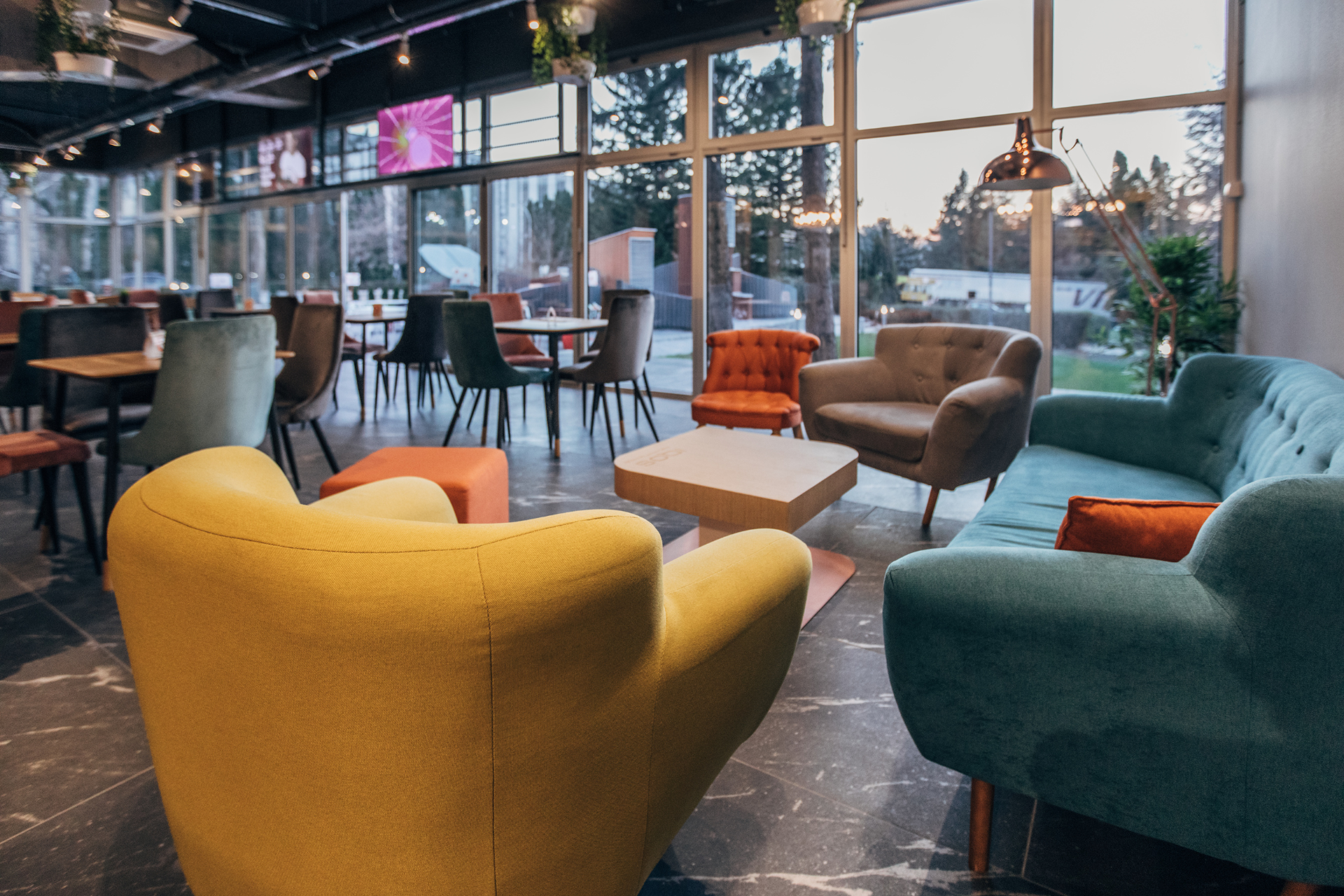 A living room filled with colorful furniture and a couch.