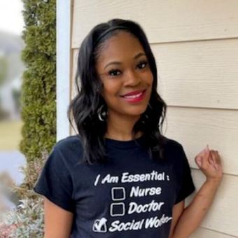 A woman wearing a t-shirt that says i am essential nurse doctor social worker