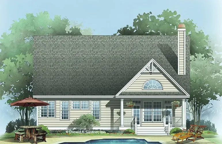 House with light yellow siding, porch, pool, and green trees.