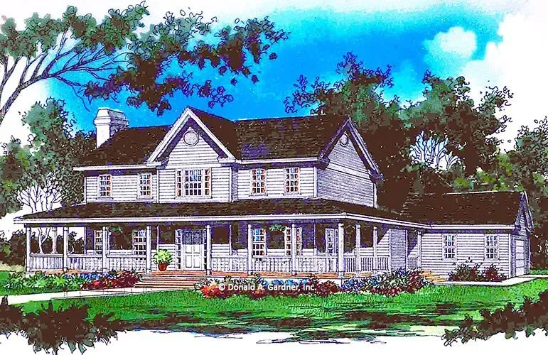 Two-story house with wraparound porch, light gray siding, dark roof, blue sky, and surrounding greenery.
