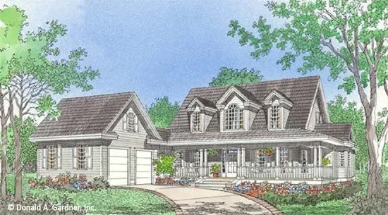 House with wrap-around porch and attached garage, surrounded by greenery. Blue sky in the background.