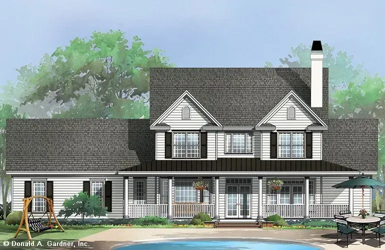 Two-story white house with dark shutters, porch, and a pool. A swing and patio set are in the yard.