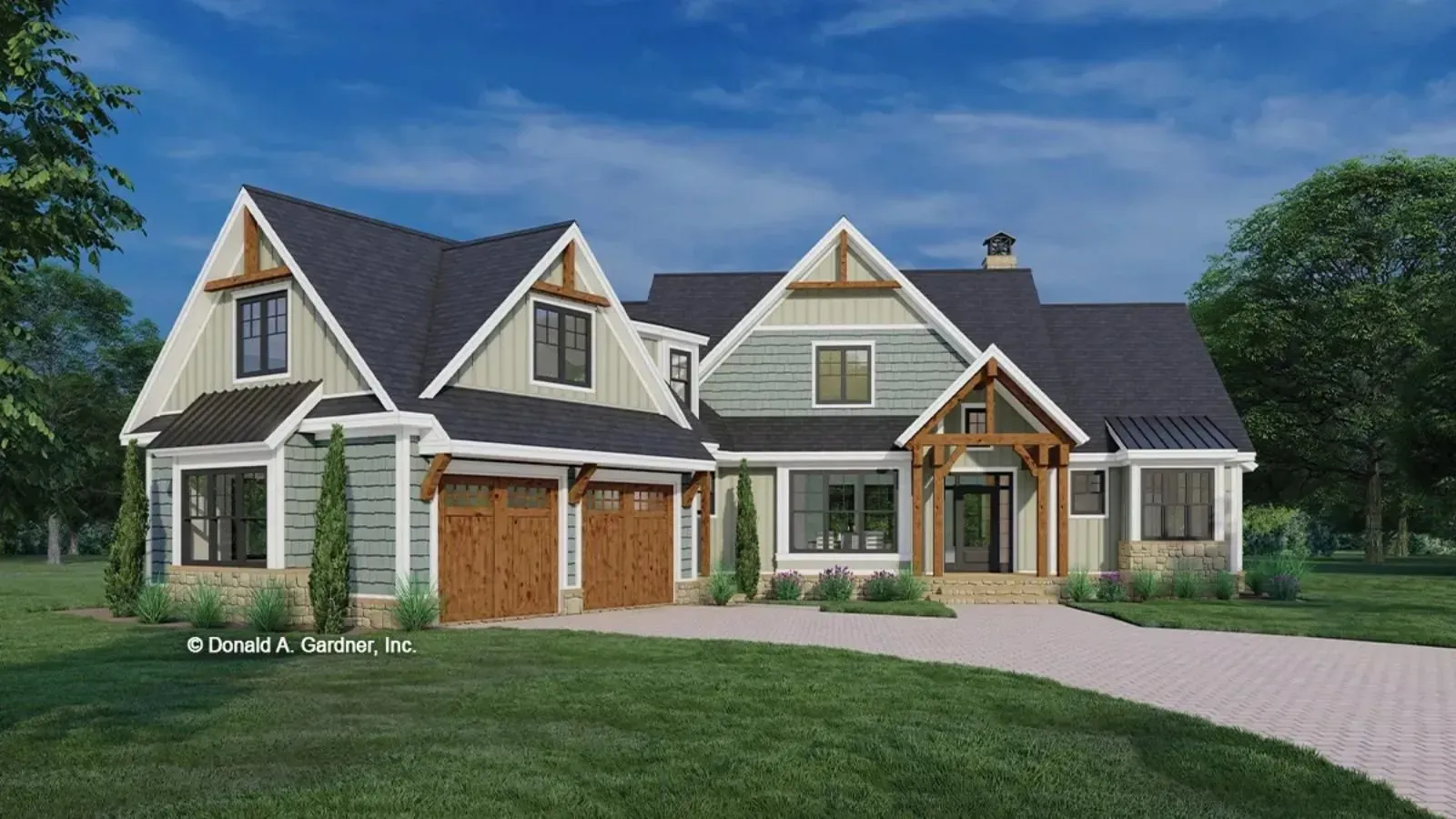 A house with a gray exterior, brown garage doors, and a stone facade on a green lawn.