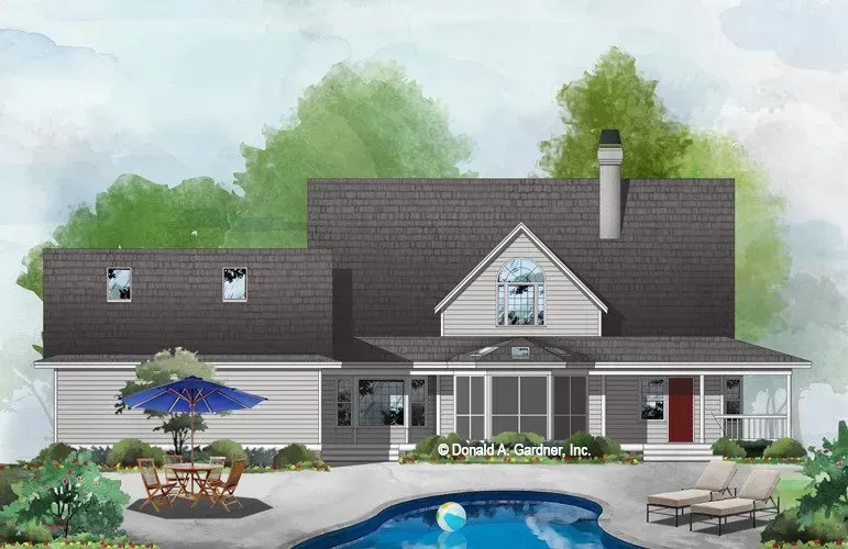 Backyard view of a two-story house with a pool and outdoor seating, trees in the background.