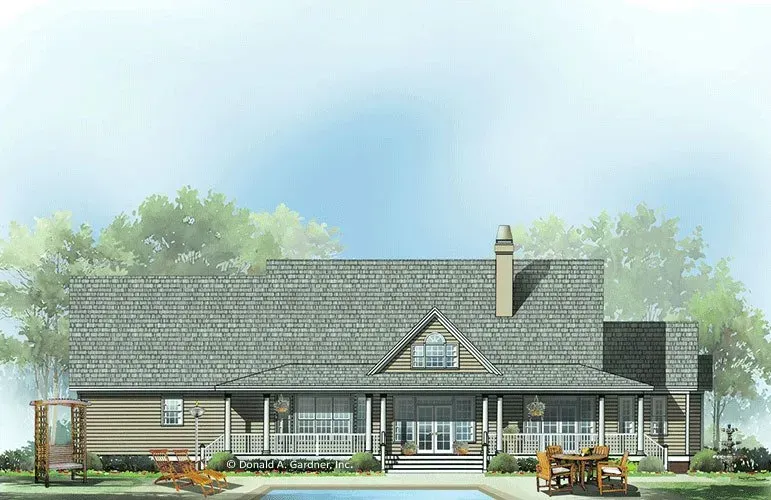 Rear view of a house with a porch, pool, and trees in the background. Gray roof, tan siding.