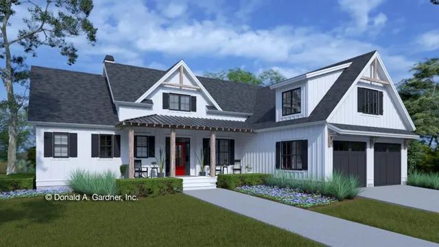 White farmhouse with black shutters, porch, and garage. Red front door. Green lawn and sky.