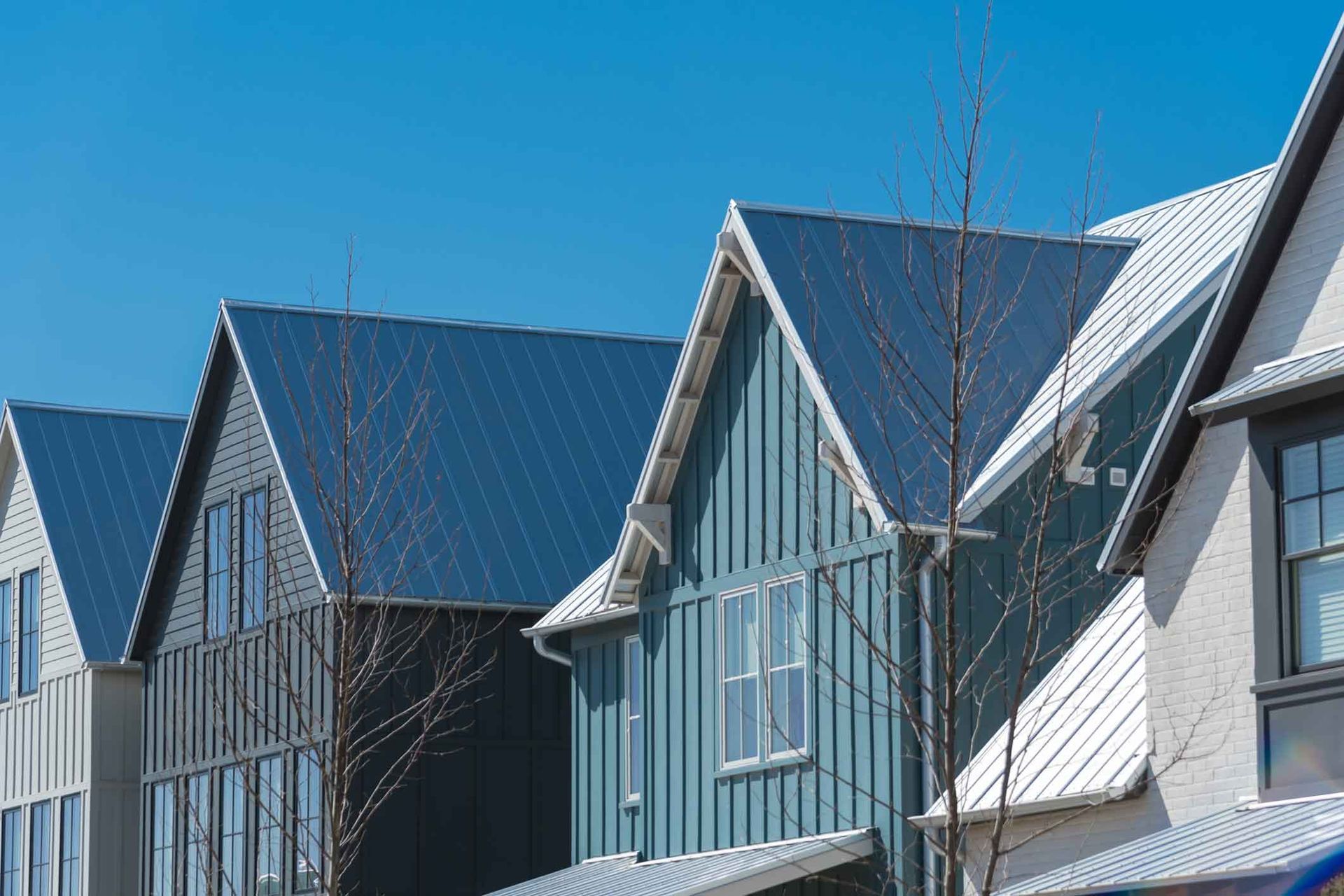 A row of houses with a blue sky in the background.