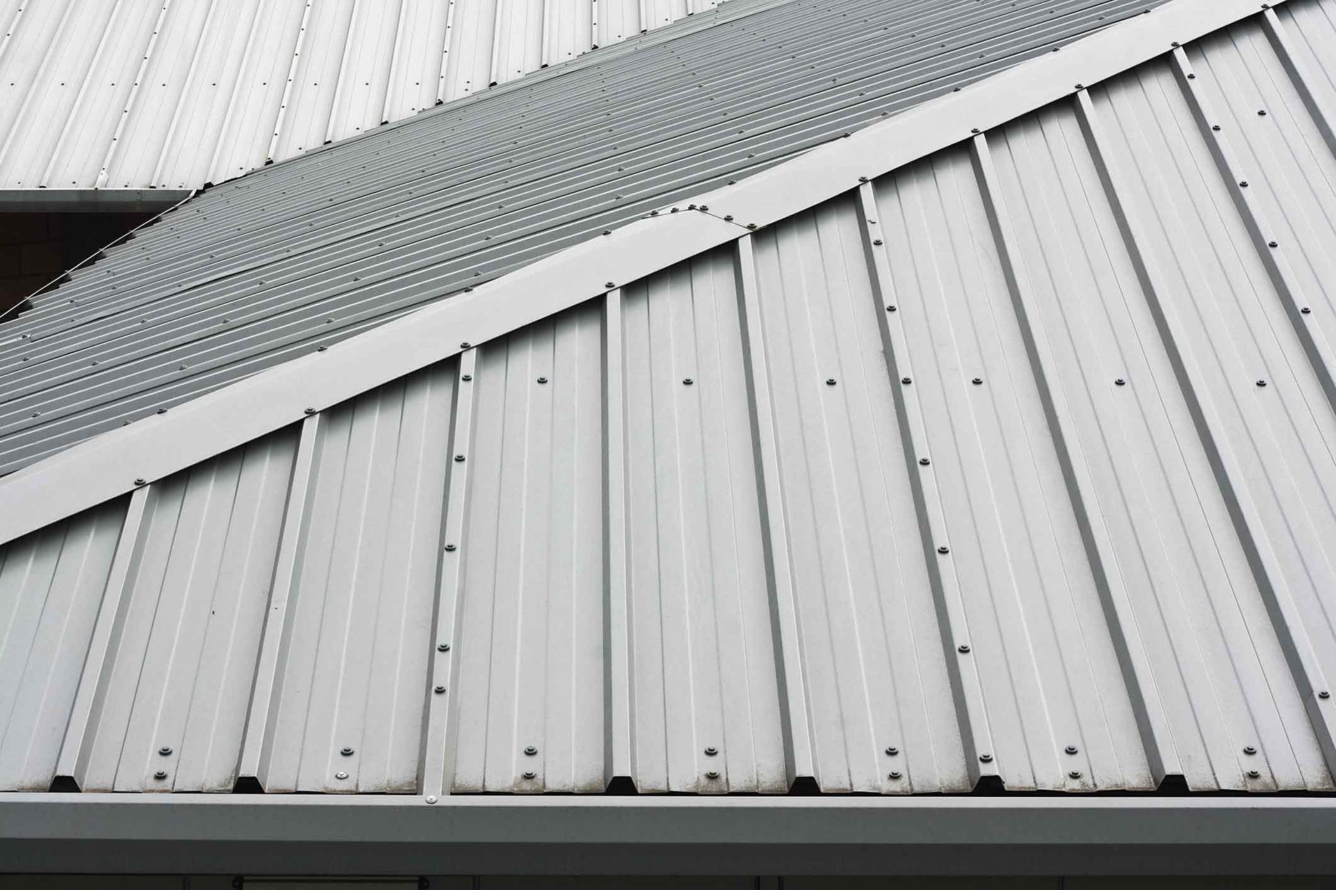 A close up of a white metal roof on a building