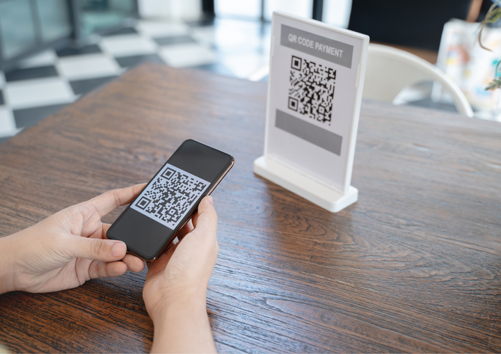 A person is using a cell phone to scan a qr code.