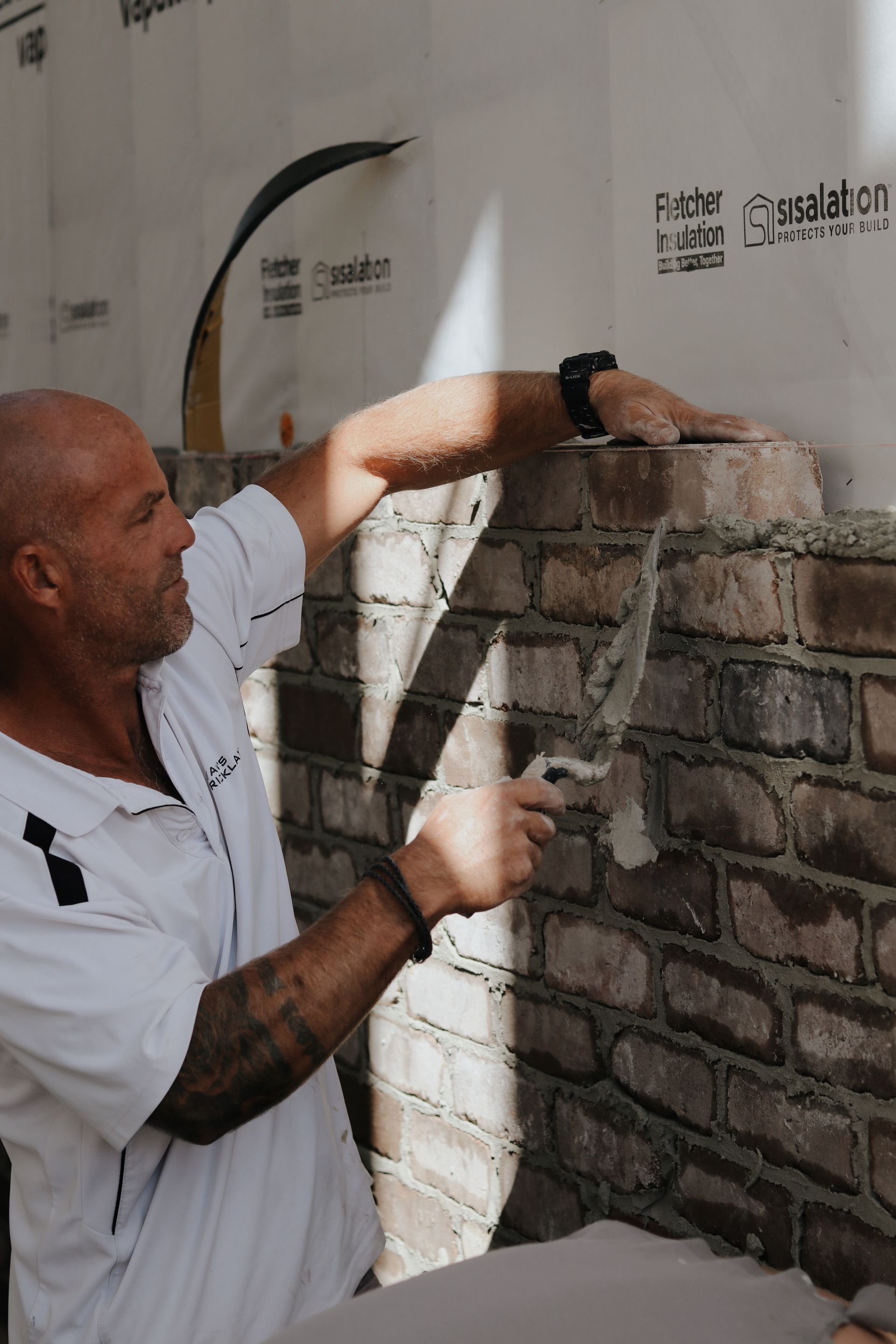 Man Laying Brick With Trowel on Construction Site — Ryan's Bricklaying In Lake Macquarie, NSW