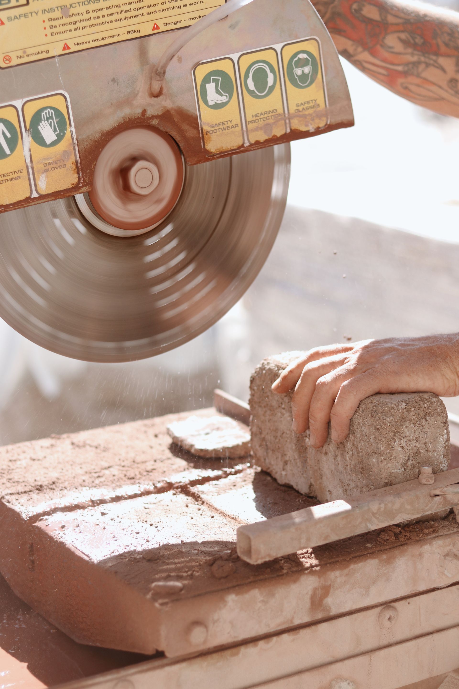 A Person Uses a Circular Saw to Cut a Brick — Ryan's Bricklaying In Cameron Park, NSW