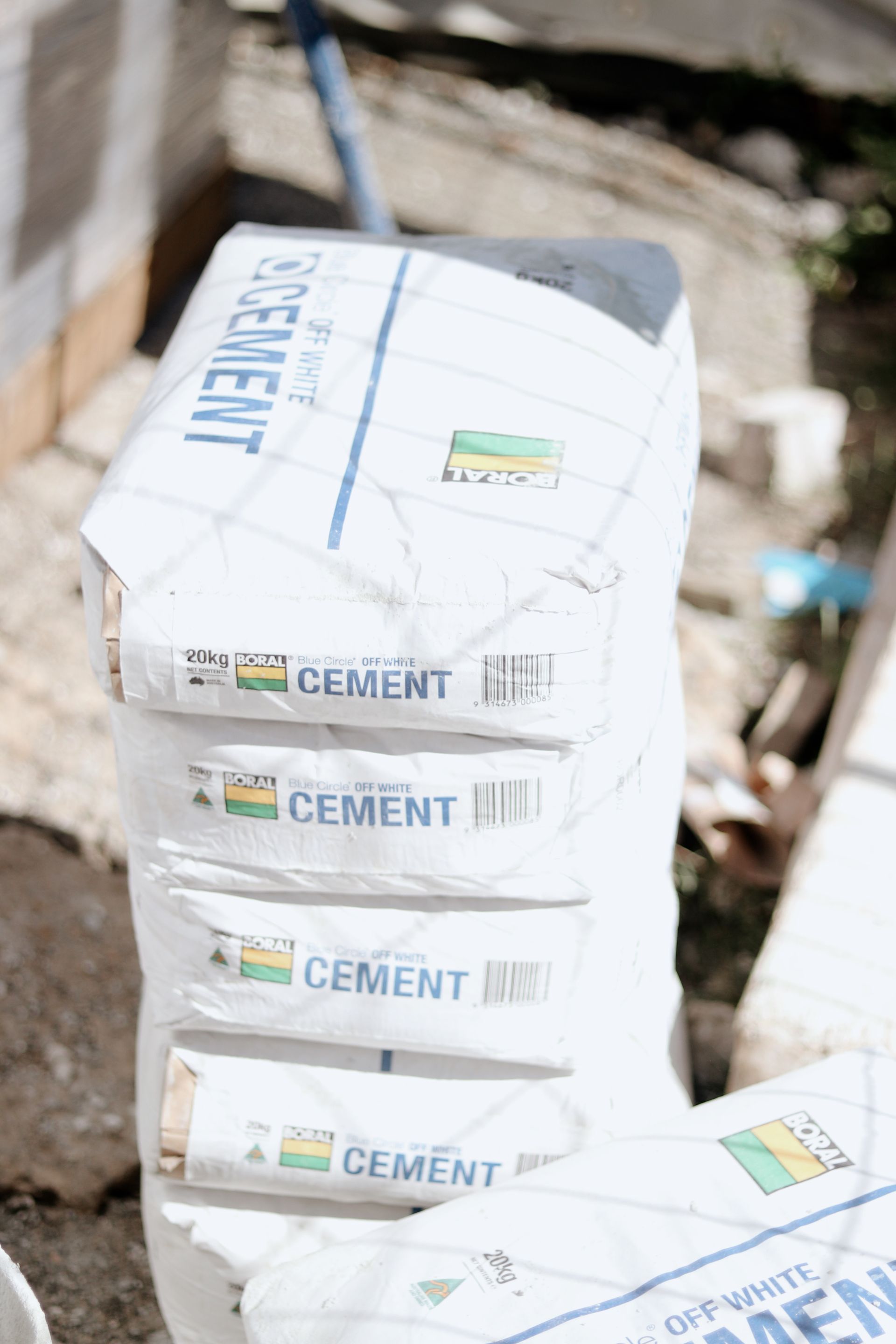 Bags of Cement Stacked Outdoors — Ryan's Bricklaying In Port Stephens, NSW