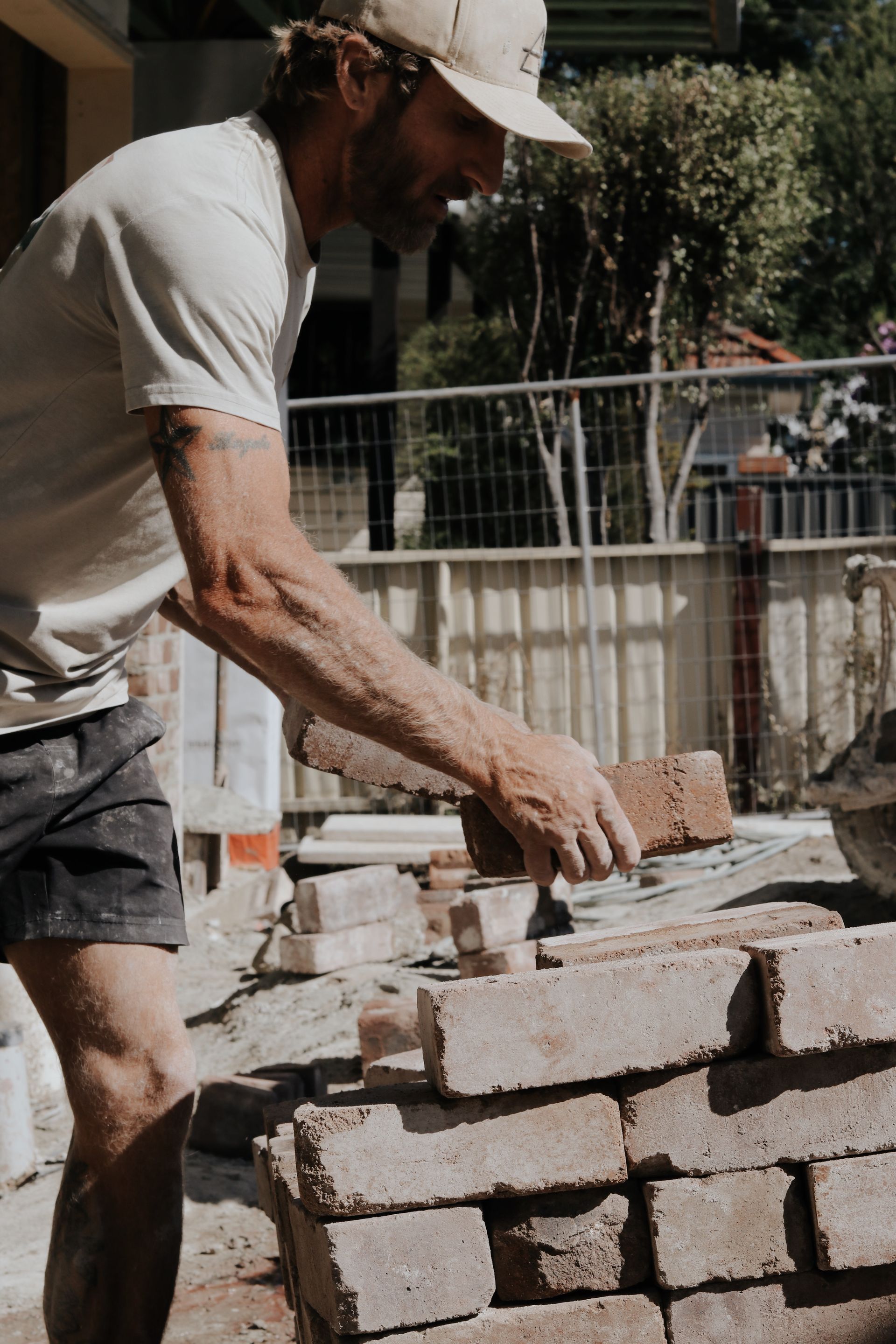 Man Laying Bricks on a Construction Site — Ryan's Bricklaying In Eleebana, NSW