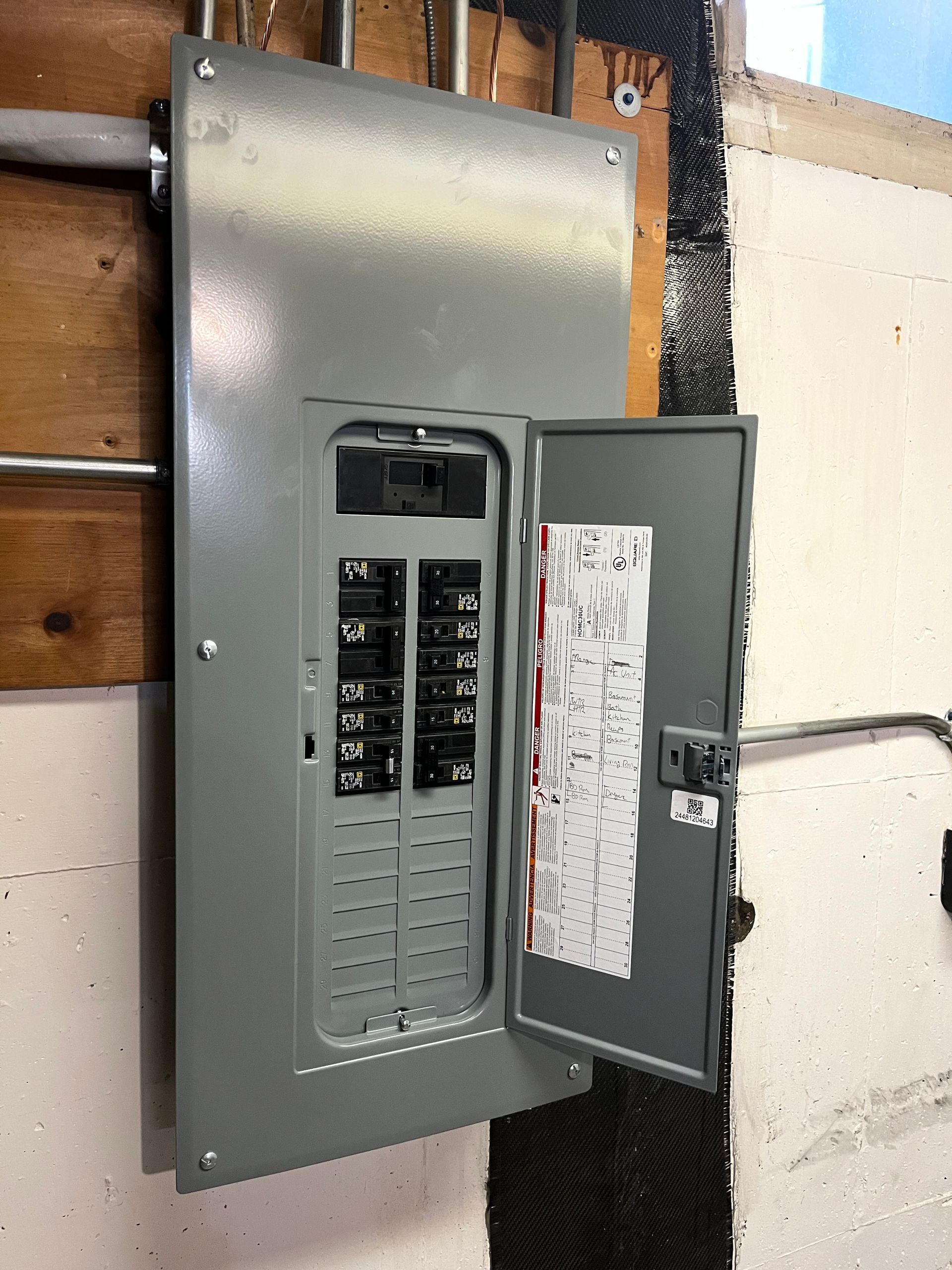 An electrical box is hanging on a wall with the door open Installed by Patriot Electrical Solutions.