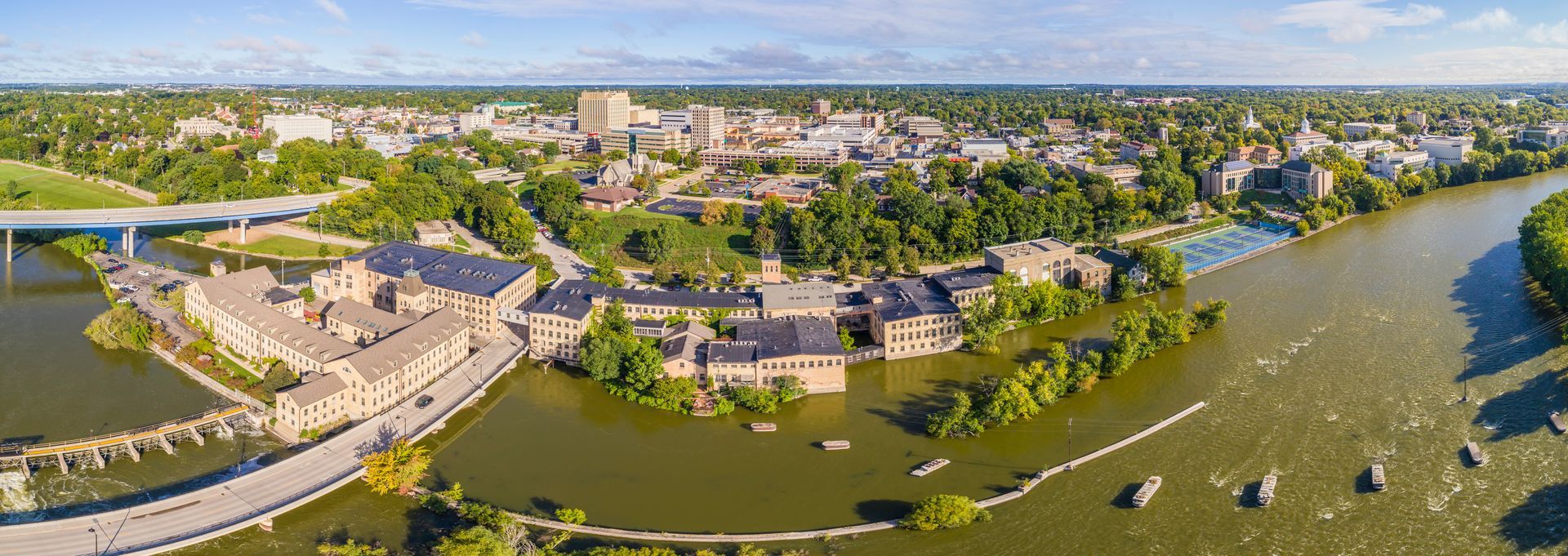 An aerial view of a city surrounded by water and trees.