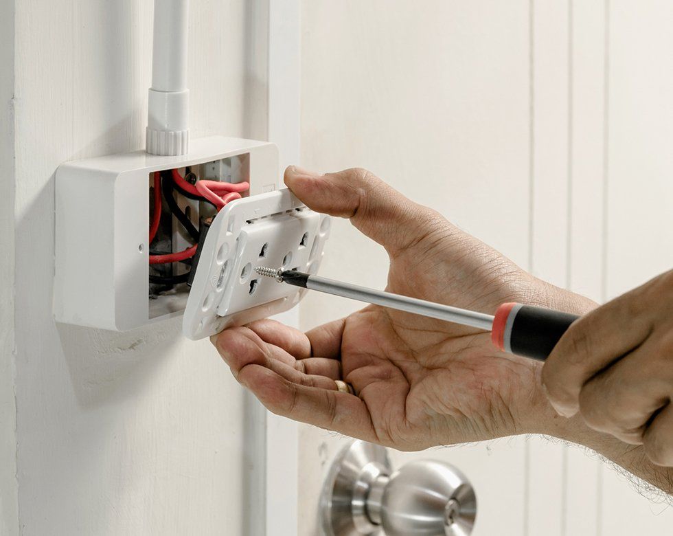 Electrical Company — Person Installing Wall Outlet in Fredericksburg, VA Electrical Company — Person Installing Wall Outlet in Fredericksburg, VA