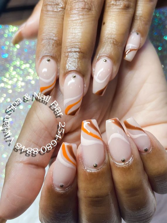 A close up of a woman 's nails with a design on them