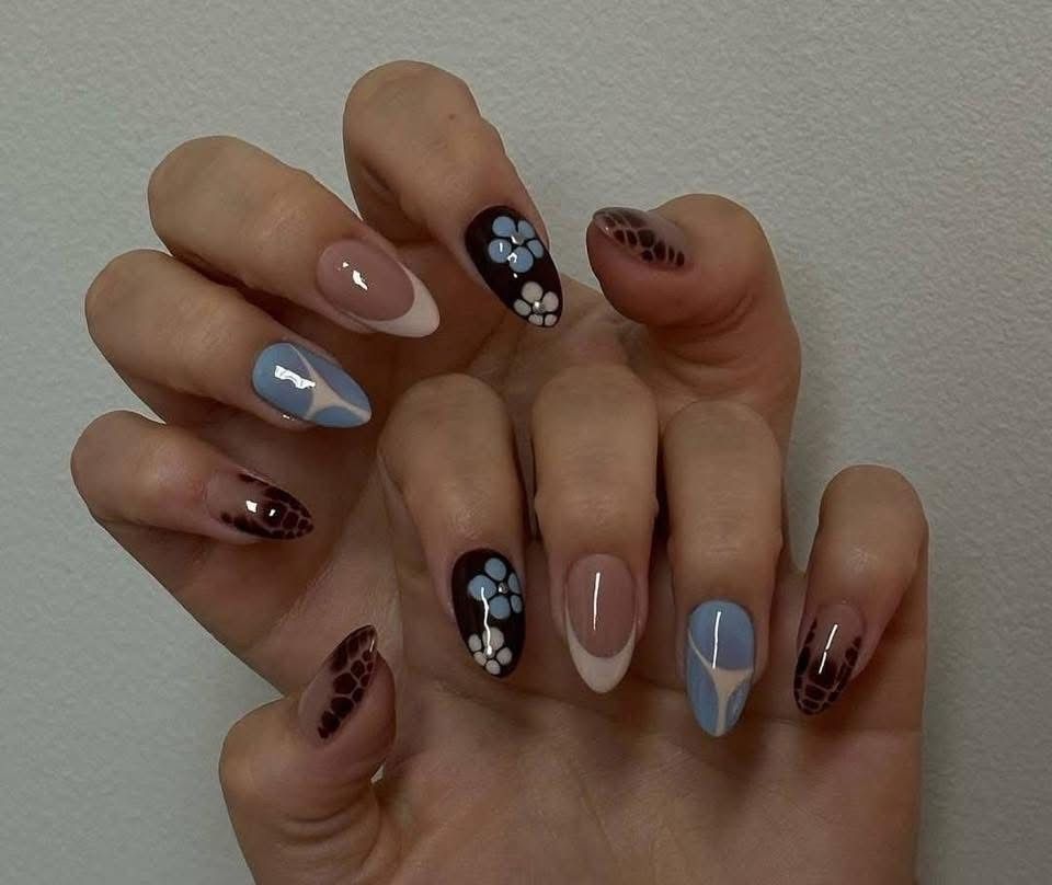 A close up of a person 's nails with flowers on them
