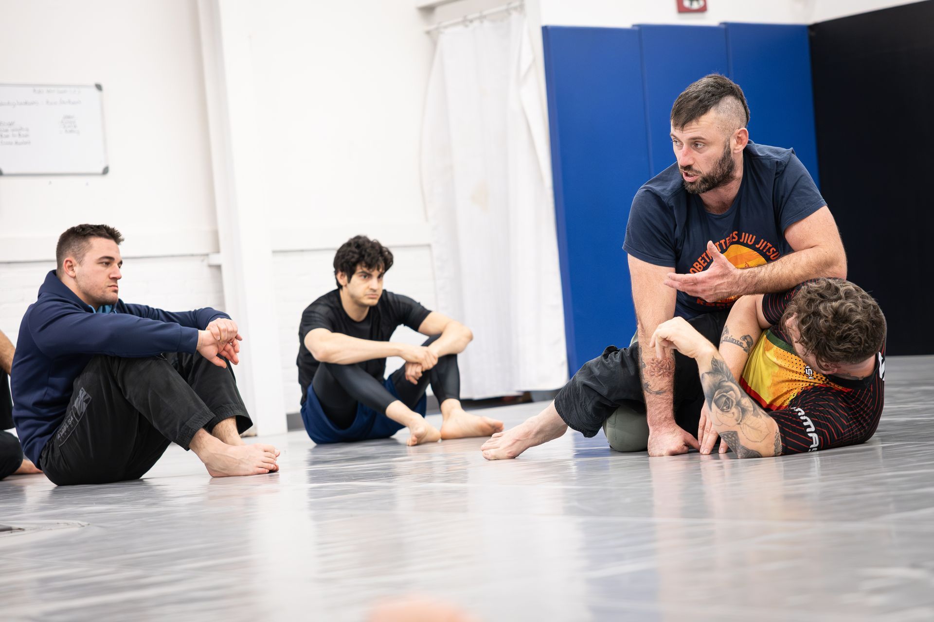 Adults practicing jiu-jitsu drills at Soulcraft Martial Arts in Hamden, CT for stress relief and focus.
