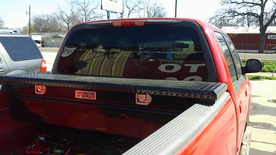 A red truck with a toolbox in the bed