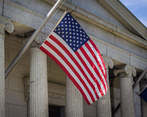 United States flag in front of court house.