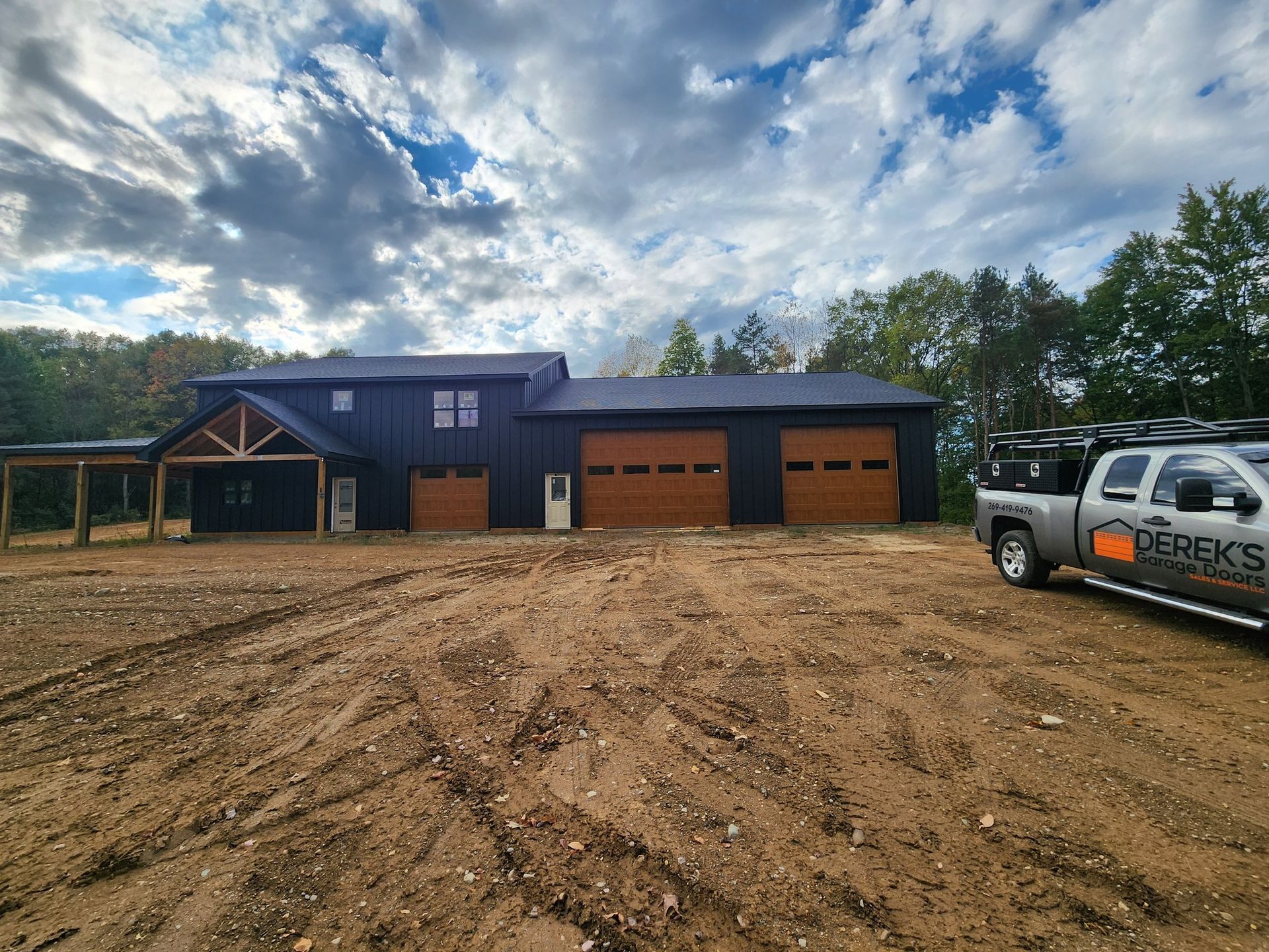 A truck is parked in front of a large house.