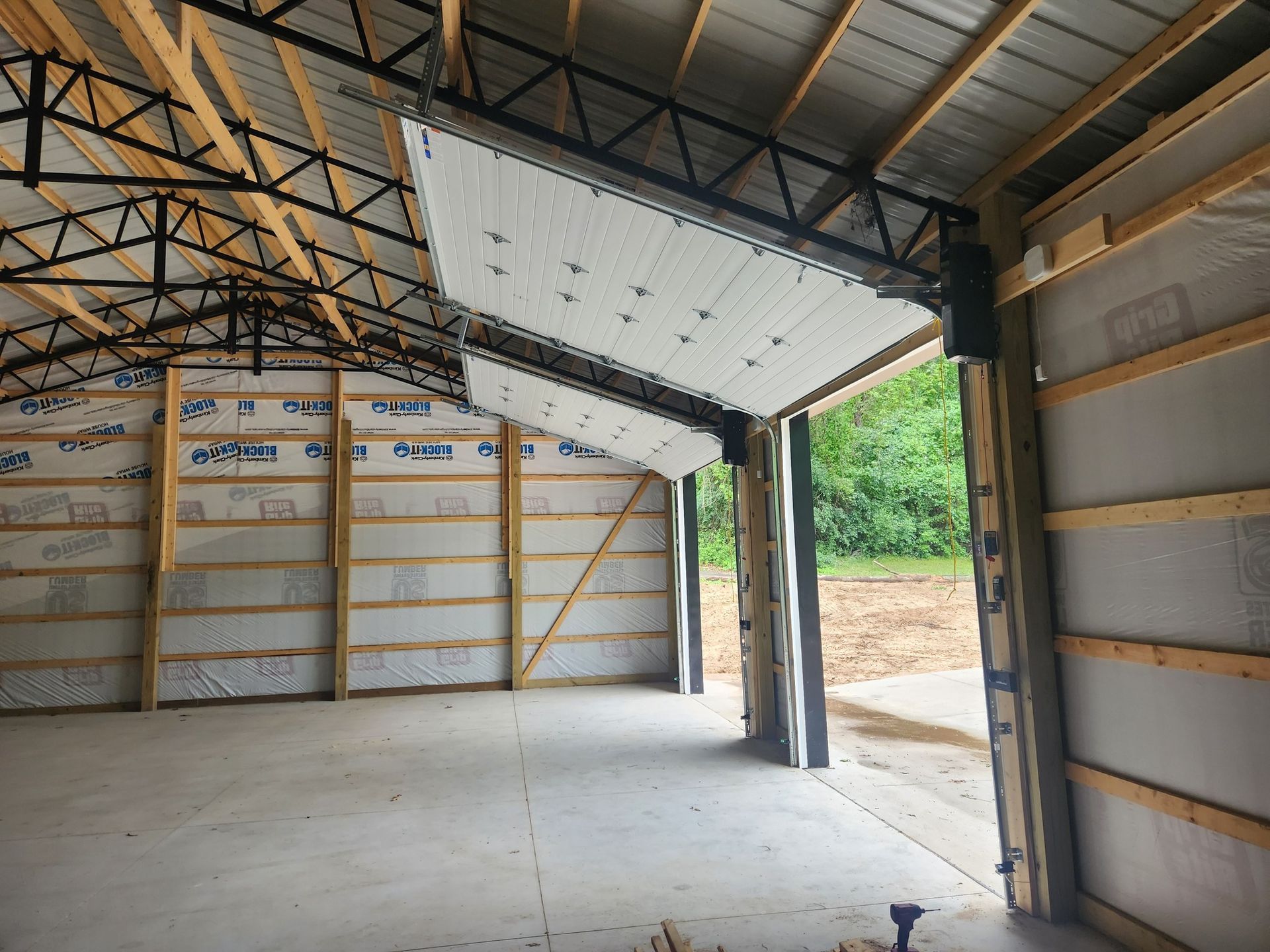 The inside of a building with a garage door open.