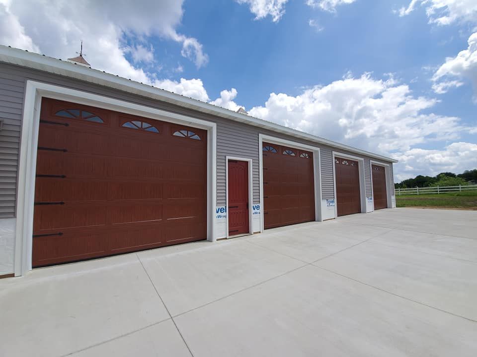 A row of garage doors on a building with a blue sky in the background.