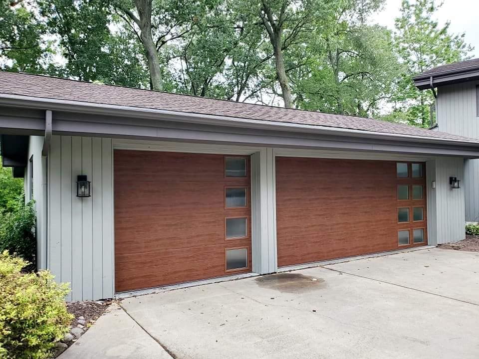 A house with two garage doors and a driveway.