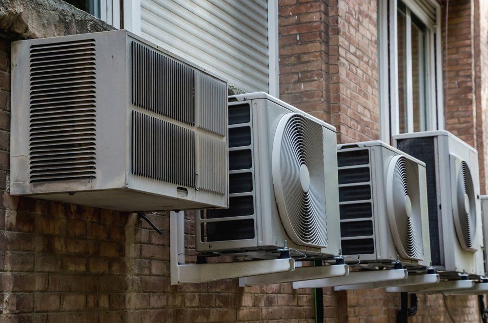 Heating And Cooling — Air Conditioner Units In A Wall in Virginia Beach, VA