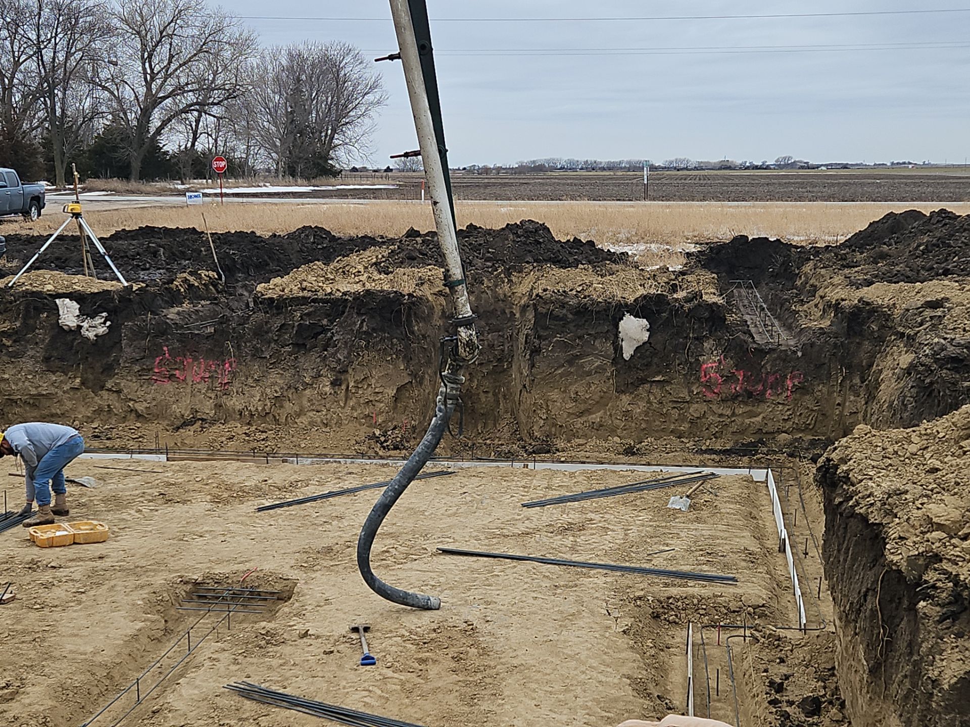 A man is digging in the dirt in a construction site.