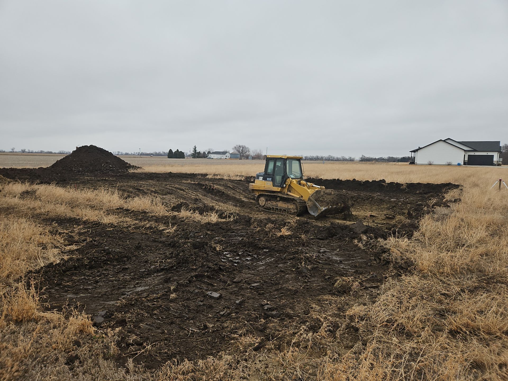 A bulldozer is moving dirt in a field.
