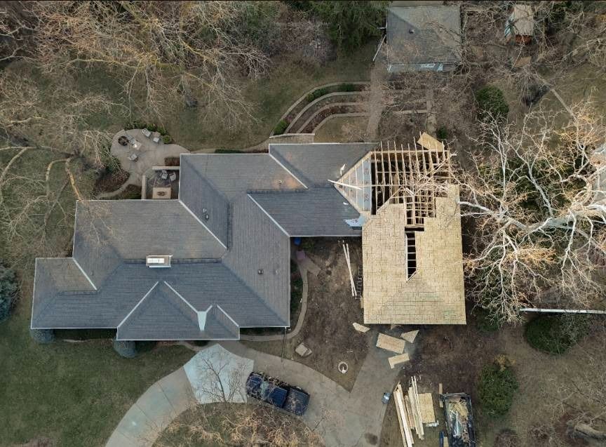An aerial view of a house under construction with a car parked in front of it.