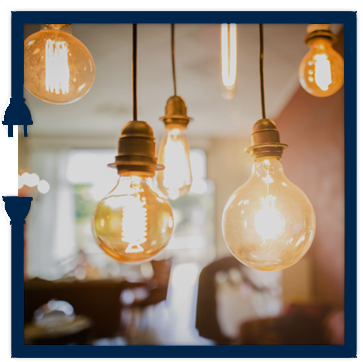 A bunch of light bulbs hanging from the ceiling in a room